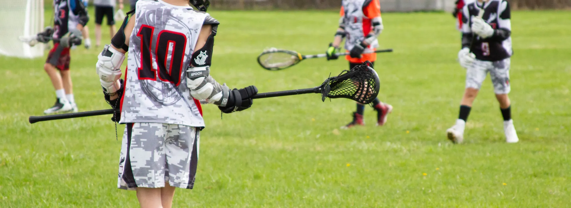 Close up of Lacrosse team member on the field.