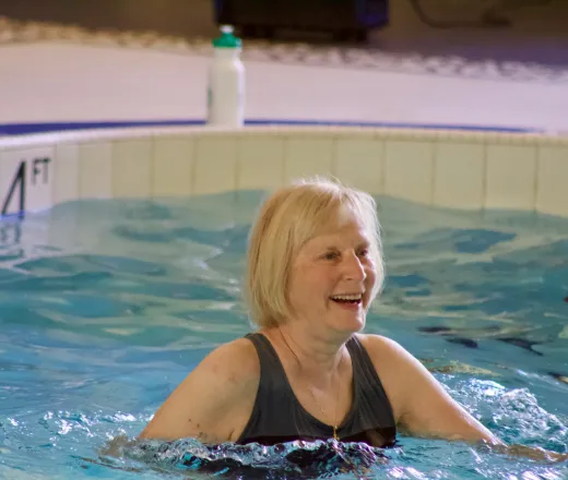 senior woman smiling enjoying aquatic exercise