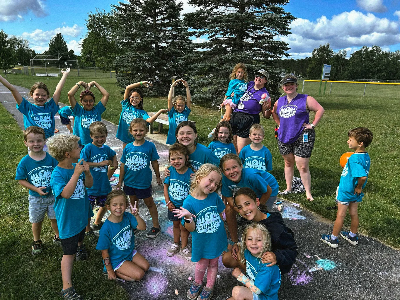 Summer camp campers gather for a group photo with counselors