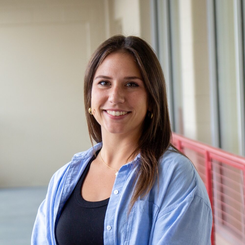 portrait image of young woman with dark hair smiling